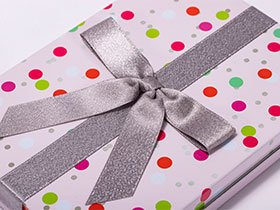 Decorative gift tin box featuring a silver ribbon bow, available from a professional tin box manufacturer.