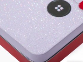 Close-up of sparkling glitter printing finish on a custom metal case from a tin box manufacturer.