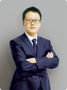 Portrait of Michael, a Sales Manager, wearing a dark blue suit and glasses, standing with arms crossed.
