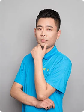 Portrait of Ryan, a Mold Engineer, in a blue polo shirt, posing thoughtfully with his hand on his chin.