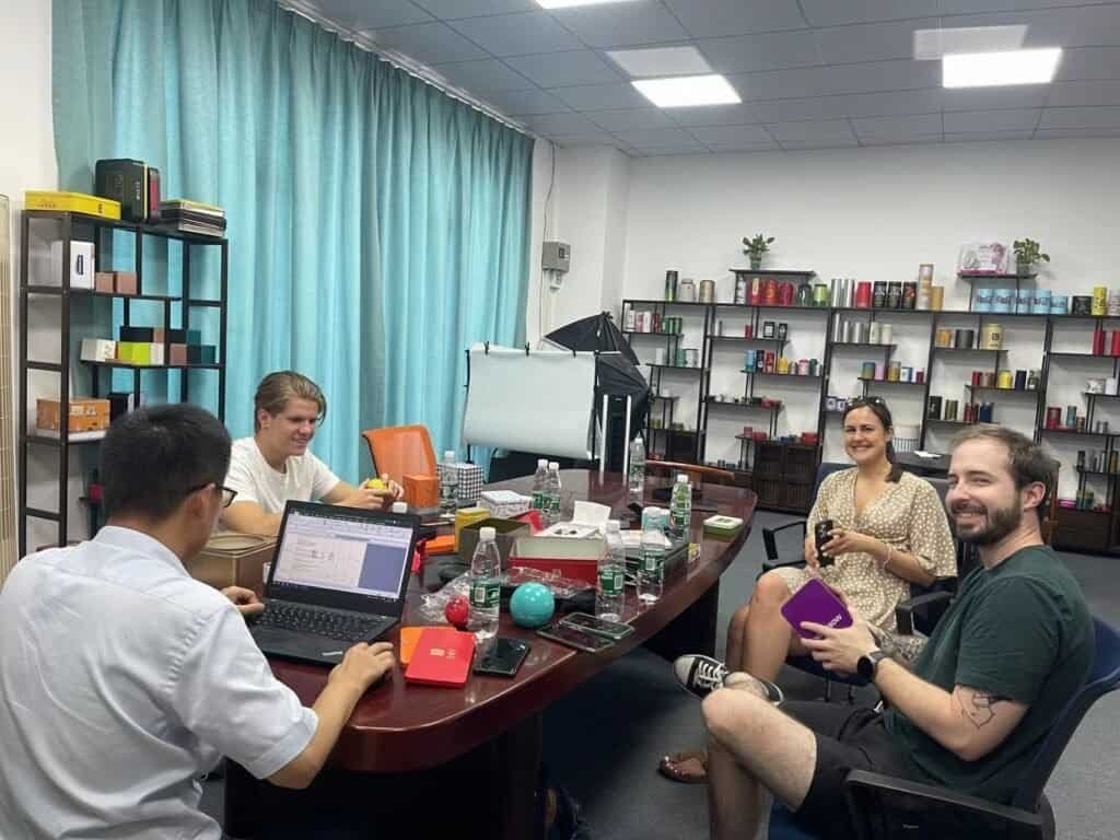 Client from Hungary reviewing custom tin box samples with TDTIN sales team