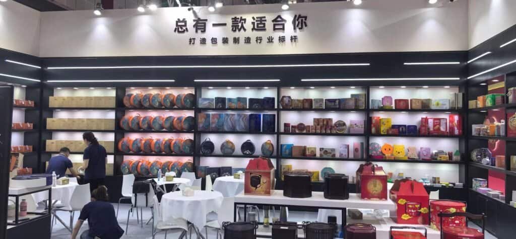 TDTIN packaging team standing at company booth during industry exhibition
