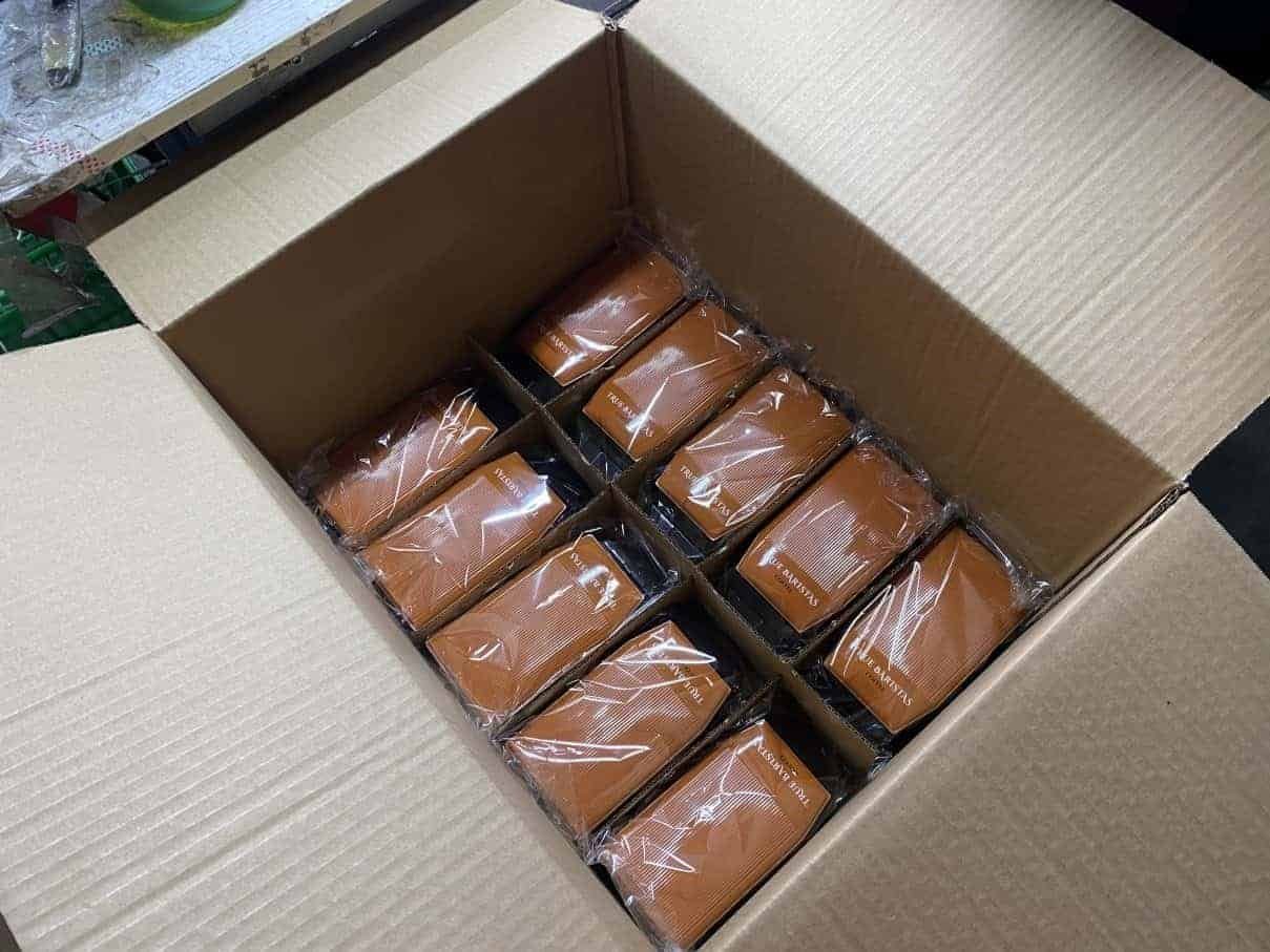 Individually wrapped C-TRON truck tins packed inside a cardboard carton