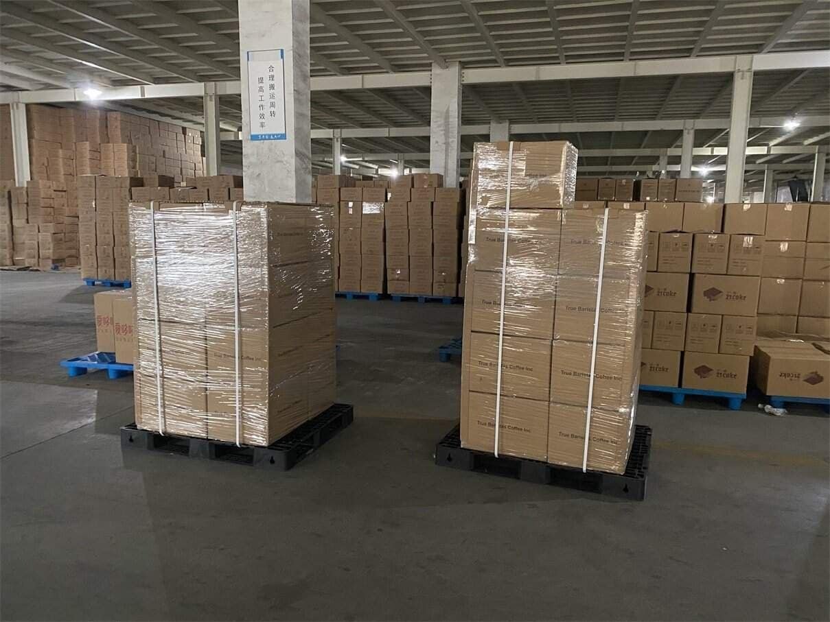Cartons stacked on pallets and secured with stretch wrap in a warehouse