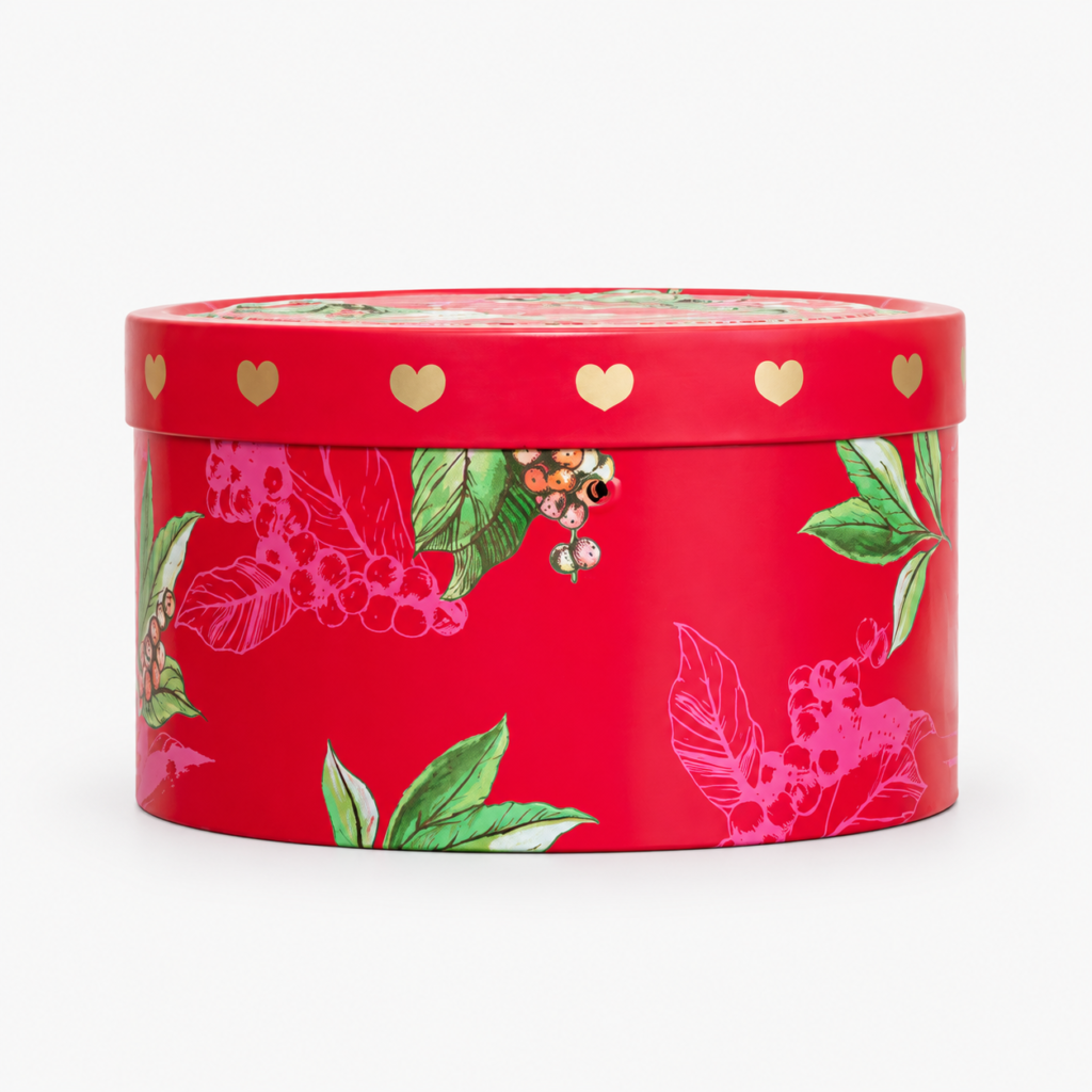 Round red gift tin with floral printing and gold hearts on the lid rim