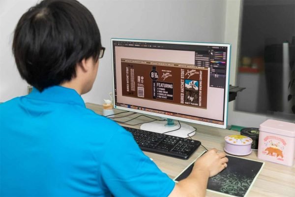 Professional designer creating a custom printing pattern for a metal tin box to ensure brand consistency.